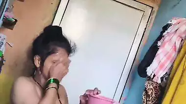 Perverted neighbor records a desi milf bathing in her bathroom